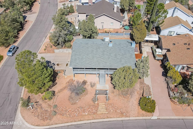 birds eye view of property with a residential view