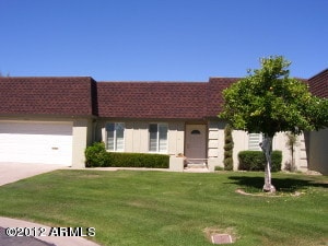 view of front of home with a front lawn and a garage