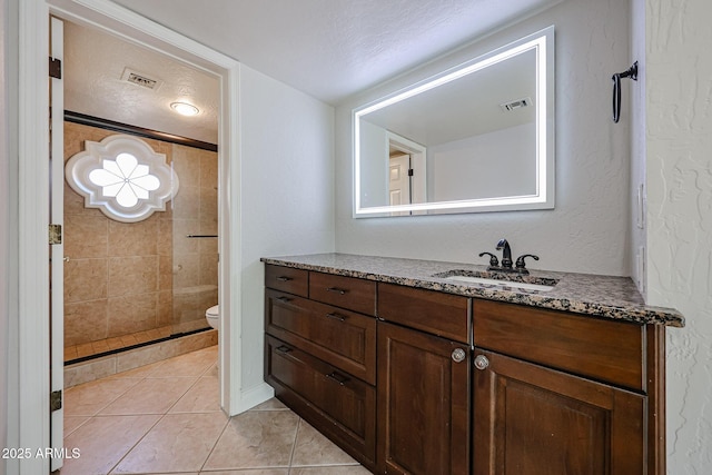 bathroom with visible vents, toilet, vanity, and tile patterned floors