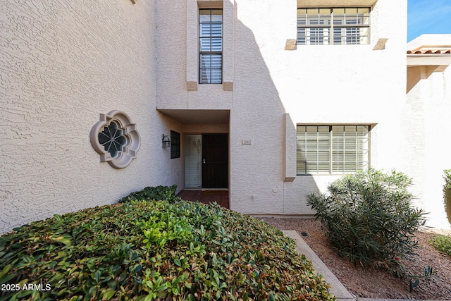 property entrance with stucco siding