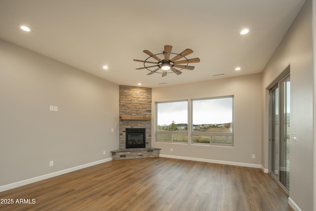 14110 E Hard Rock Rd, Prescott Valley, AZ 86315 - unfurnished living room with wood finished floors, recessed lighting, a stone fireplace, a ceiling fan, and baseboards