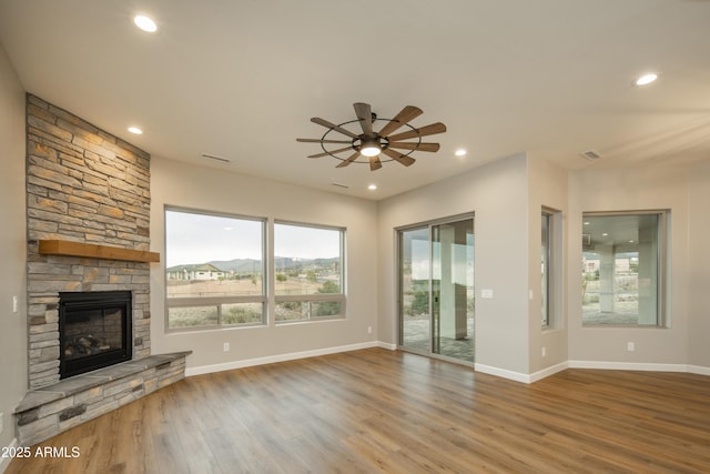 14110 E Hard Rock Rd, Prescott Valley, AZ 86315 - unfurnished living room featuring wood finished floors, ceiling fan, a stone fireplace, recessed lighting, and baseboards