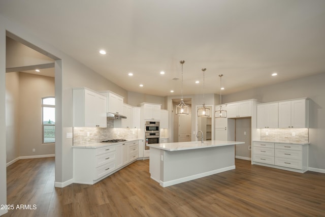 14110 E Hard Rock Rd, Prescott Valley, AZ 86315 - kitchen featuring appliances with stainless steel finishes, tasteful backsplash, under cabinet range hood, recessed lighting, and white cabinets