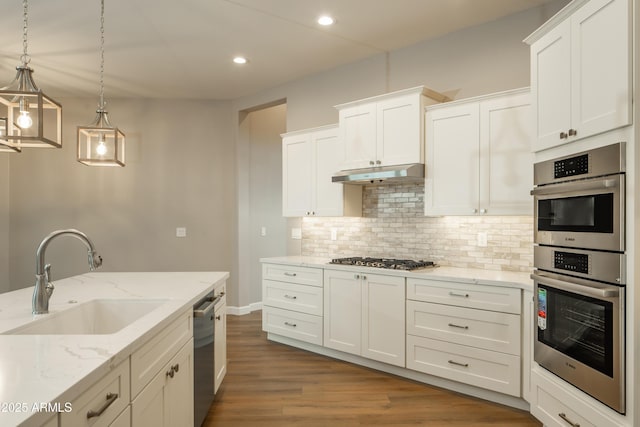 14110 E Hard Rock Rd, Prescott Valley, AZ 86315 - kitchen with a sink, appliances with stainless steel finishes, under cabinet range hood, backsplash, and white cabinetry