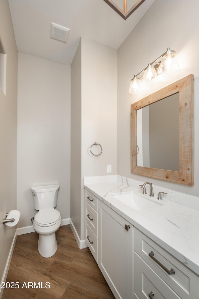 14110 E Hard Rock Rd, Prescott Valley, AZ 86315 - bathroom featuring wood finished floors, baseboards, toilet, and vanity