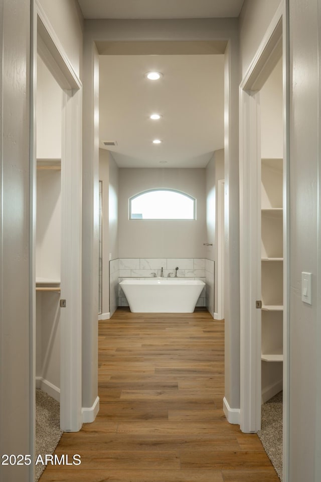 14110 E Hard Rock Rd, Prescott Valley, AZ 86315 - bathroom featuring a soaking tub, wood finished floors, recessed lighting, and baseboards