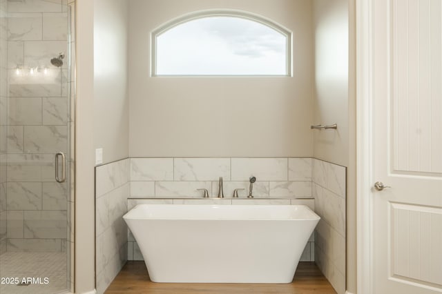 14110 E Hard Rock Rd, Prescott Valley, AZ 86315 - full bathroom featuring a shower stall, tile walls, wood finished floors, a freestanding tub, and wainscoting