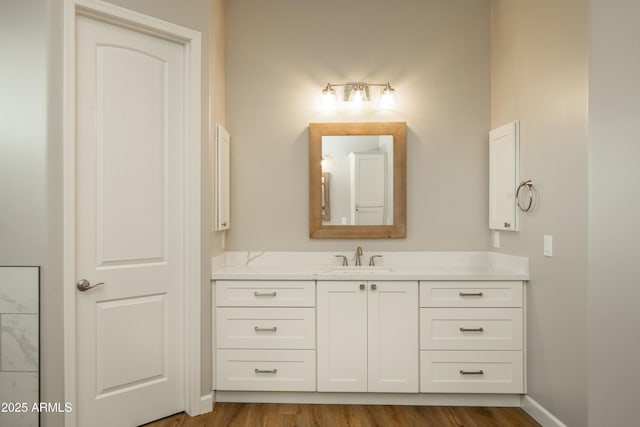 14110 E Hard Rock Rd, Prescott Valley, AZ 86315 - bathroom with wood finished floors, vanity, and baseboards