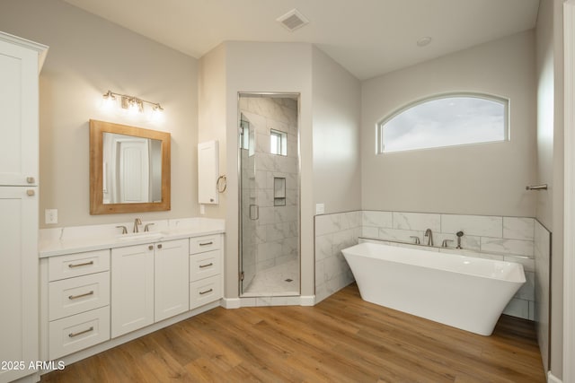 14110 E Hard Rock Rd, Prescott Valley, AZ 86315 - full bath with a shower stall, vanity, wood finished floors, a soaking tub, and tile walls