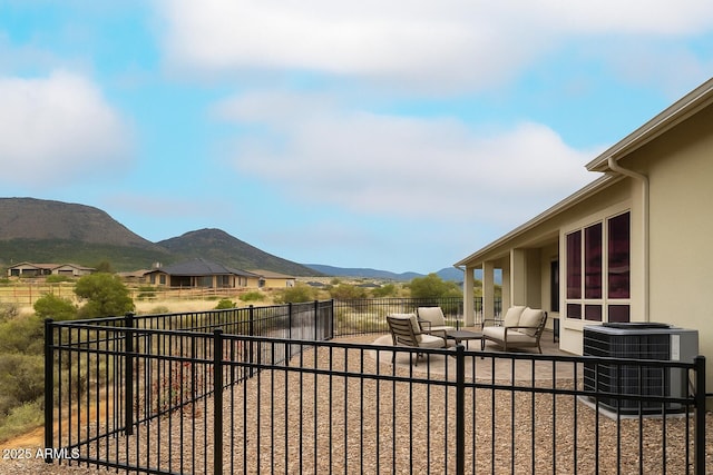 14110 E Hard Rock Rd, Prescott Valley, AZ 86315 - fenced backyard featuring central air condition unit, an outdoor hangout area, a mountain view, and a patio