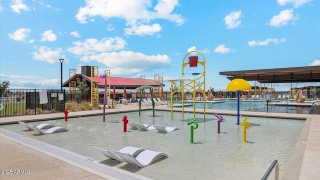 view of jungle gym featuring fence