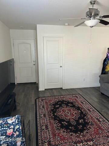 interior space with dark wood-style floors and a ceiling fan