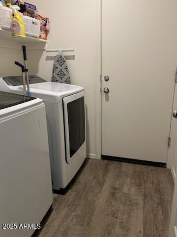 washroom with laundry area, wood finished floors, and independent washer and dryer