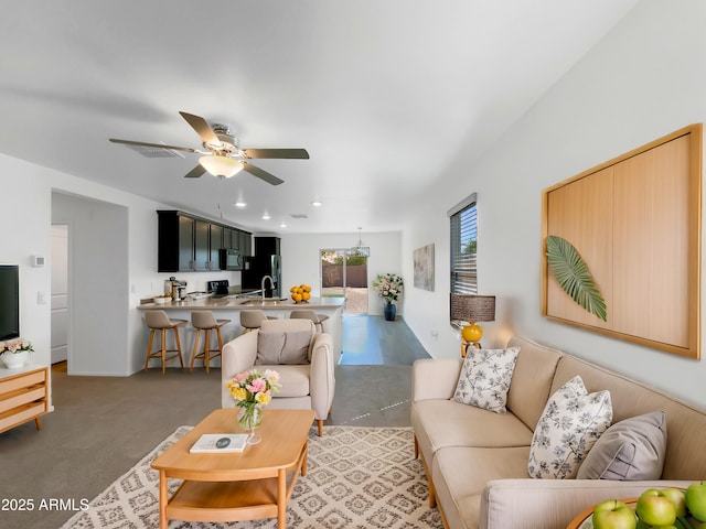 living area featuring recessed lighting and ceiling fan