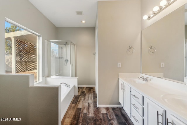 bathroom featuring vanity, plus walk in shower, and hardwood / wood-style flooring