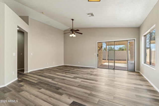 6658 E San Cristobal Way, Gold Canyon, AZ 85118 - spare room with plenty of natural light, a ceiling fan, wood finished floors, lofted ceiling, and baseboards