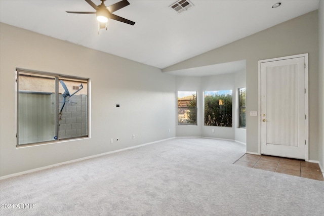 unfurnished room with ceiling fan, light colored carpet, and lofted ceiling