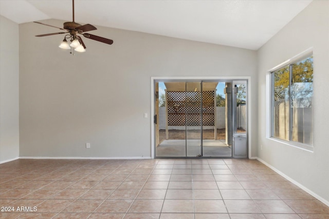 tiled spare room with ceiling fan and vaulted ceiling