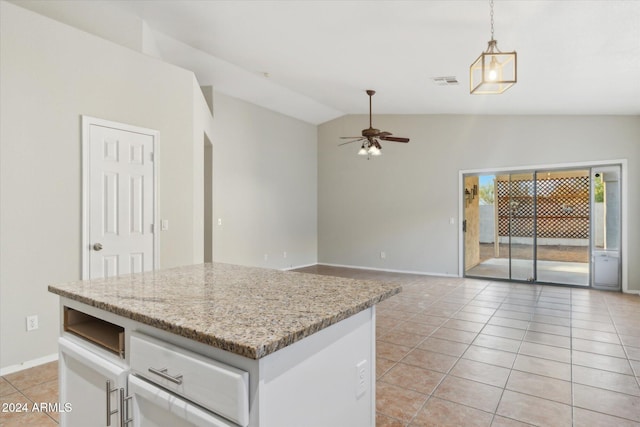 kitchen with light tile patterned floors, white cabinetry, hanging light fixtures, and lofted ceiling