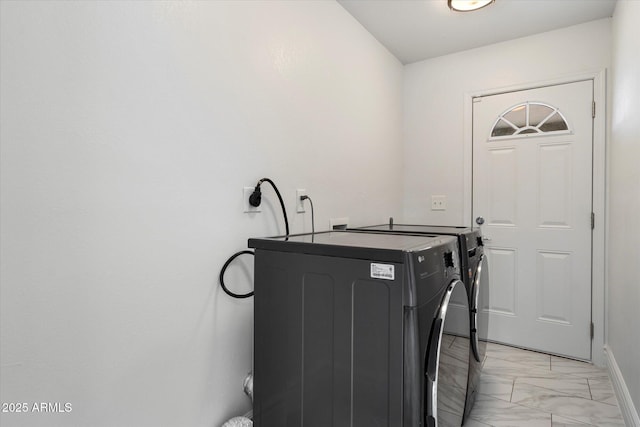 laundry room with marble finish floor, independent washer and dryer, and laundry area