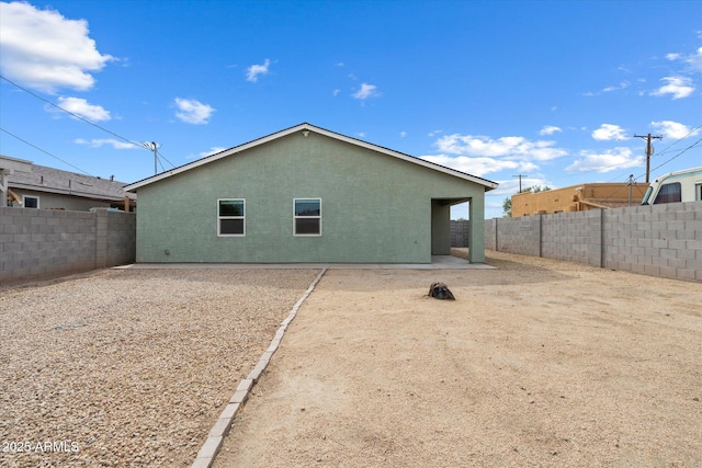 back of property featuring a patio area, a fenced backyard, and stucco siding