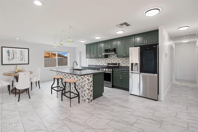 kitchen featuring exhaust hood, dark countertops, visible vents, and stainless steel appliances