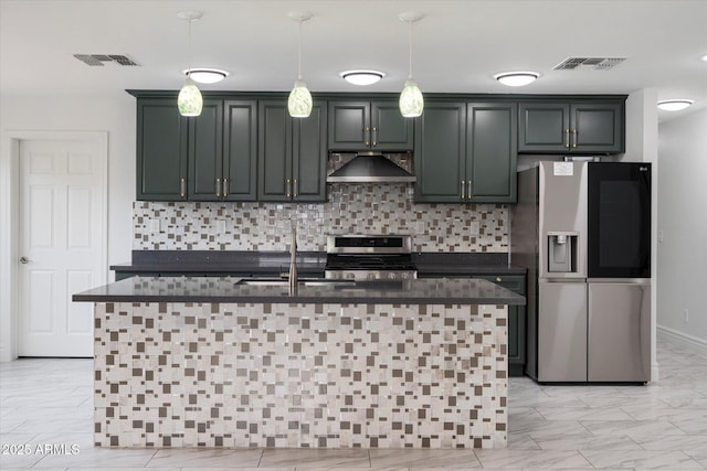 kitchen with stainless steel appliances, visible vents, decorative backsplash, and wall chimney range hood