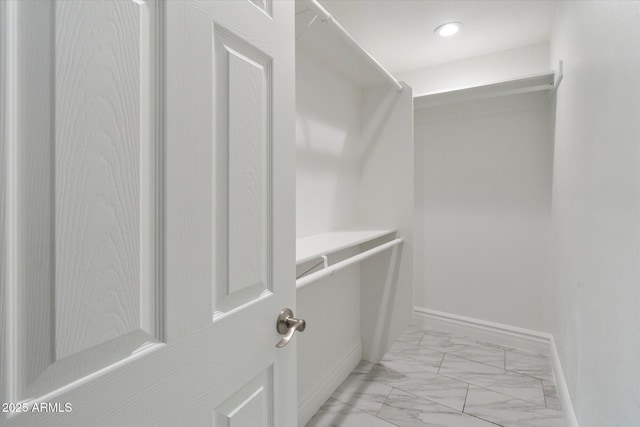 spacious closet with marble finish floor