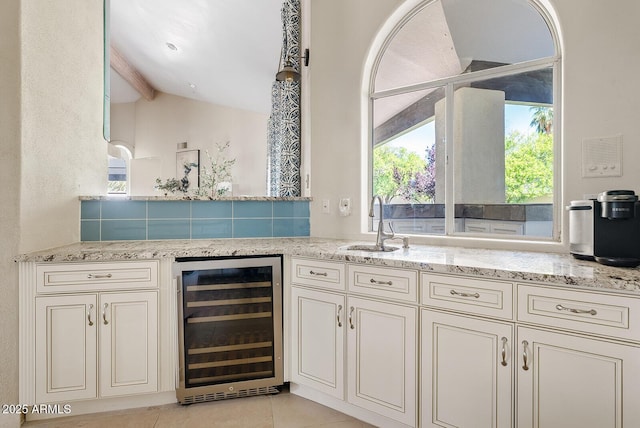 10205 E Corrine Dr, Scottsdale, AZ 85260 - bar with wine cooler, a sink, and light tile patterned floors