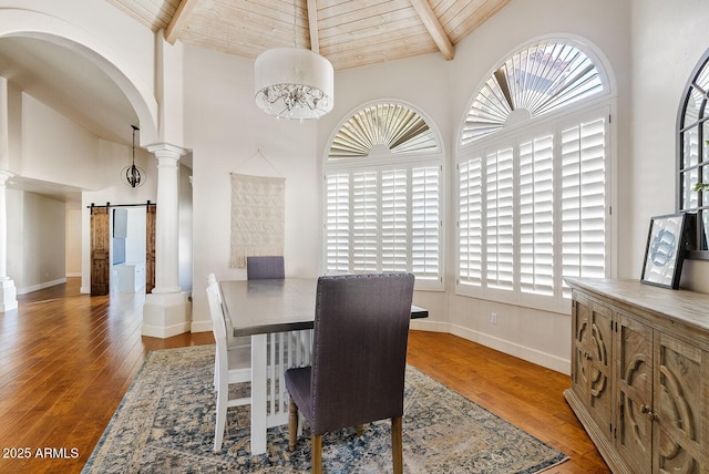 10205 E Corrine Dr, Scottsdale, AZ 85260 - dining area featuring a barn door, ornate columns, high vaulted ceiling, arched walkways, and wood ceiling with exposed beams