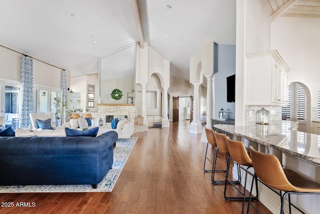 10205 E Corrine Dr, Scottsdale, AZ 85260 - living area with ornate columns, high vaulted ceiling, beam ceiling, and wood-type flooring