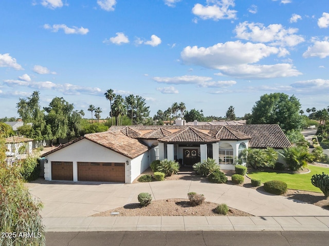 10205 E Corrine Dr, Scottsdale, AZ 85260 - mediterranean / spanish-style home featuring an attached garage, driveway, stucco siding, and a tiled roof