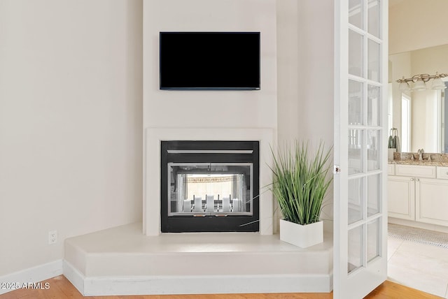 10205 E Corrine Dr, Scottsdale, AZ 85260 - detailed view of a sink, a glass covered fireplace, and baseboards