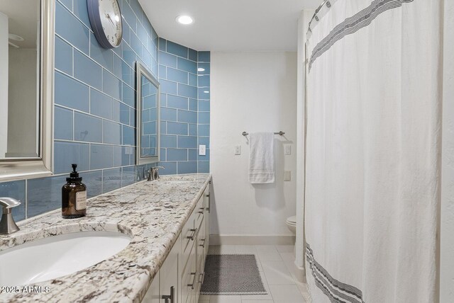10205 E Corrine Dr, Scottsdale, AZ 85260 - full bathroom with tile patterned floors, toilet, double vanity, baseboards, and tile walls