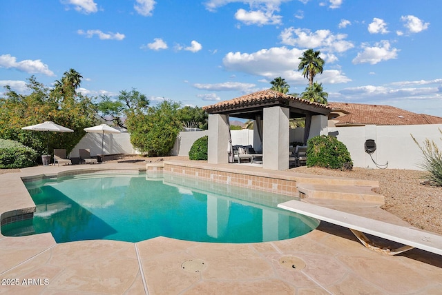 10205 E Corrine Dr, Scottsdale, AZ 85260 - view of pool featuring a gazebo, a patio area, a fenced backyard, a diving board, and an outdoor living space