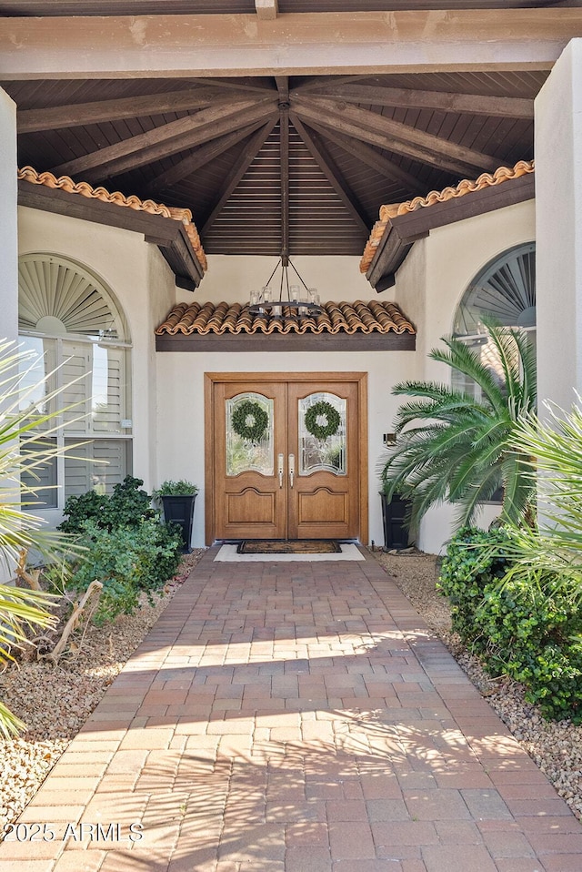 10205 E Corrine Dr, Scottsdale, AZ 85260 - property entrance with a tile roof, french doors, and stucco siding