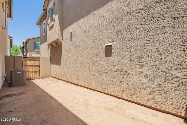 5812 W Illini St, Phoenix, AZ 85043 - view of side of home with stucco siding and a gate