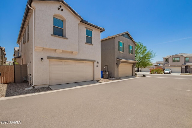 5812 W Illini St, Phoenix, AZ 85043 - view of front facade with a garage and stucco siding
