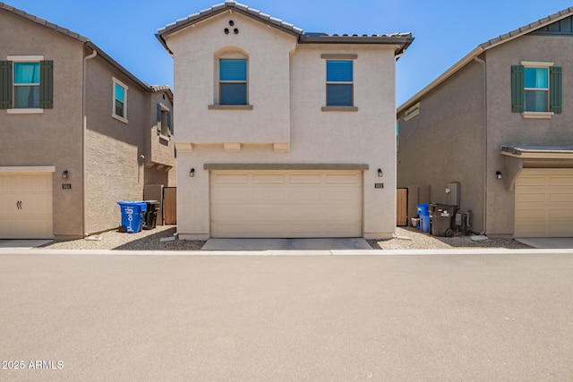 5812 W Illini St, Phoenix, AZ 85043 - view of front facade with stucco siding, a garage, and a tiled roof
