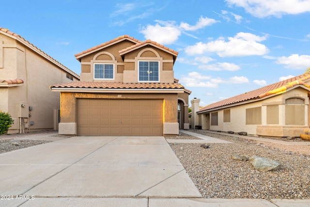 mediterranean / spanish-style home featuring a garage