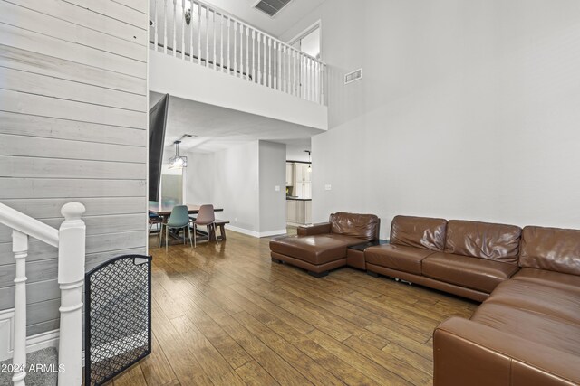 living room with wood-type flooring and a high ceiling