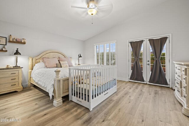 bedroom featuring ceiling fan, vaulted ceiling, light wood-type flooring, and access to exterior