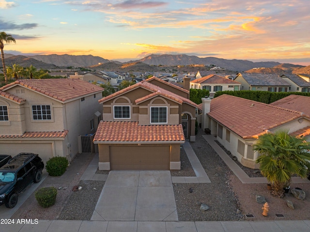 mediterranean / spanish house featuring a mountain view and a garage