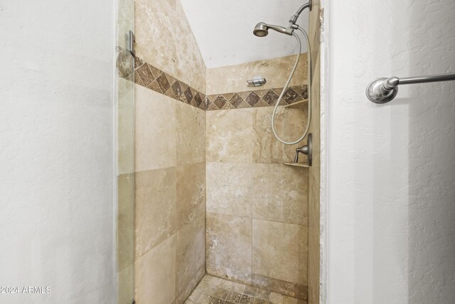 bathroom with a tile shower