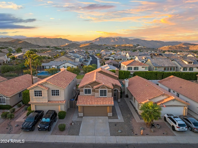 aerial view at dusk featuring a mountain view