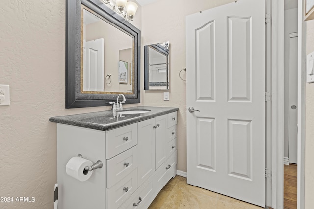 bathroom with hardwood / wood-style floors and vanity