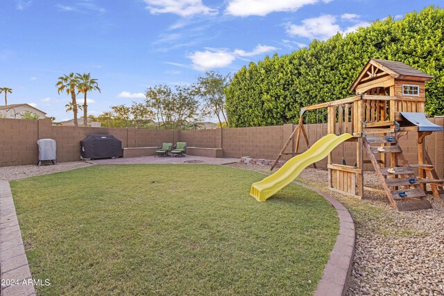 view of jungle gym featuring a patio and a yard