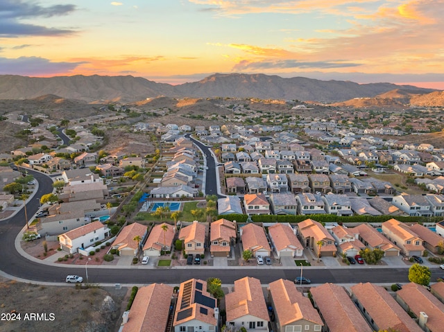 aerial view at dusk featuring a mountain view