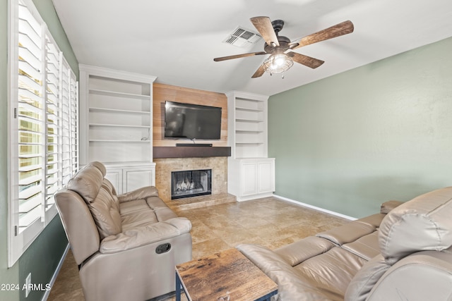 living room featuring built in shelves and ceiling fan