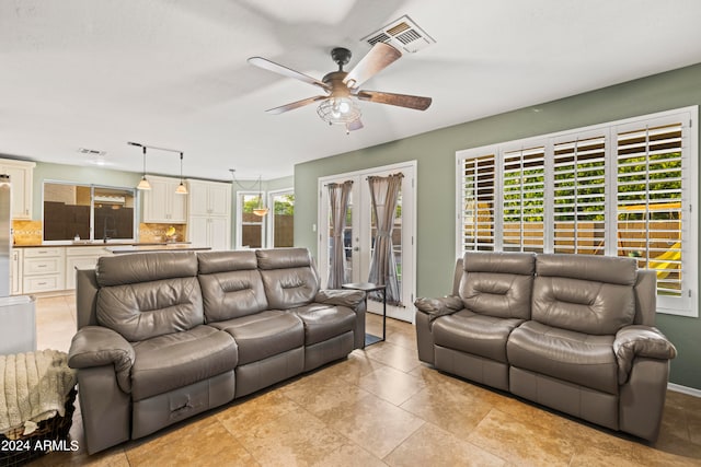 tiled living room with ceiling fan